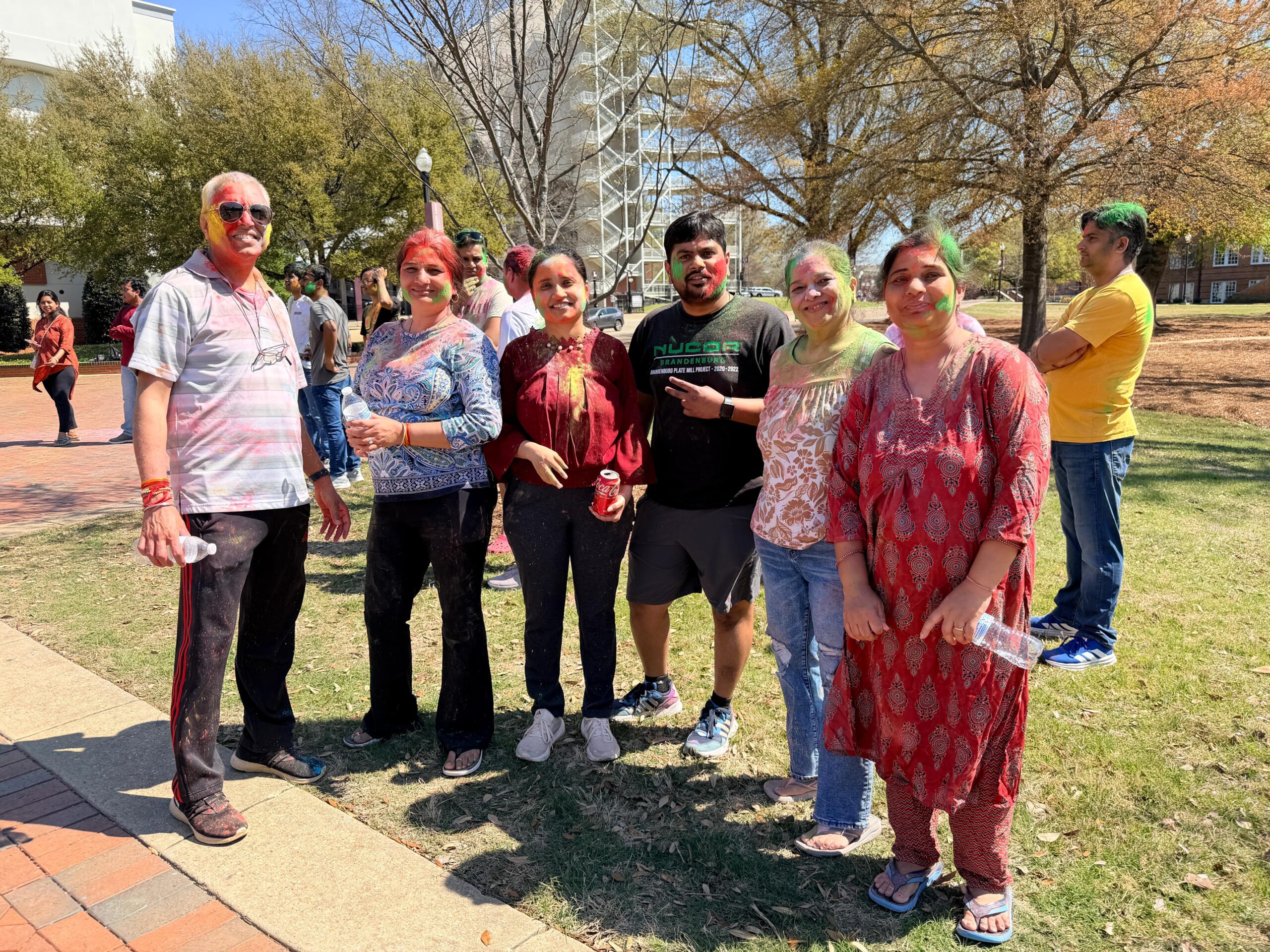 People Standing in line with holi colors